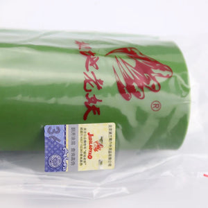 Close-up of bright green latex band roll for slingshots, 15 cm wide