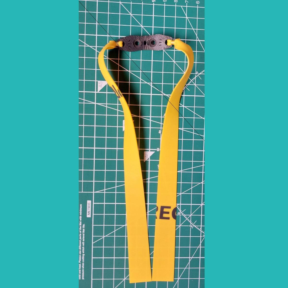 A user drawing the band back to its full mid pull length, demonstrating the steady pull needed for consistent performance.